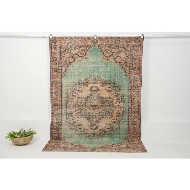 Vintage Hand-Knotted runner rug is a semi-antique vintage area rug. The '70s Eastern region of Anatolia's unique rug is...