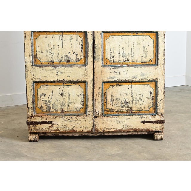 An 18th century painted wardrobe from Spain, displaying a particular Andalusian folk art style in a charming color palette...