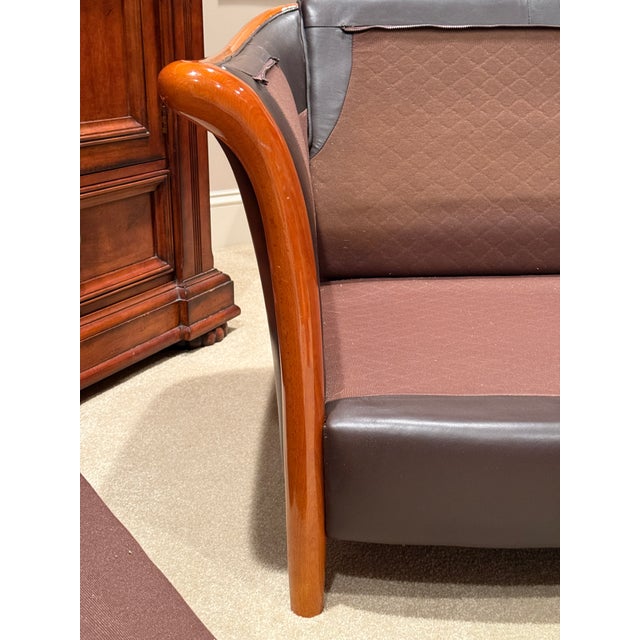 Soft chocolate color leather sofa made in Italy. Feather back and side cushions. Beautiful polished caramel colored wood...