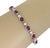 This elegant Estate tennis bracelet is crafted from 14k white gold featuring 13 half bezel pear shape ruby gemstone set in...