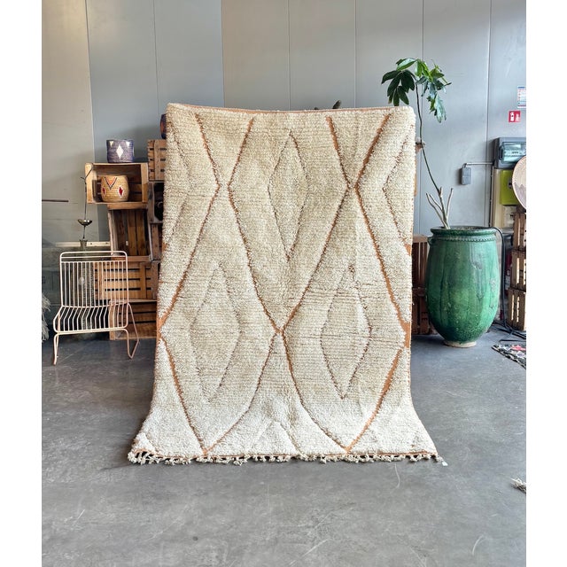 A refined contemporary interpretation of the iconic Beni Ourain rug, handwoven from natural wool by Berber artisans. The...