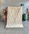 A refined contemporary interpretation of the iconic Beni Ourain rug, handwoven from natural wool by Berber artisans. The...