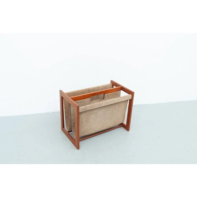 A solid teak magazine rack designed by Danish designer Aksel Kjersgaard in the 1960s. The frame is made of solid teak and...