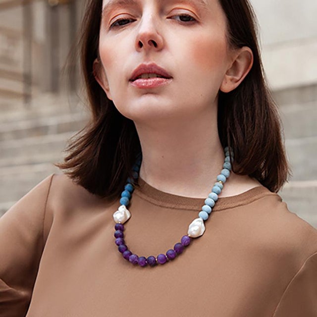 Handmade ceramic beads from Malta run the top, matte, porous, two shades of sky blue. Matte amethyst from Siberia takes...