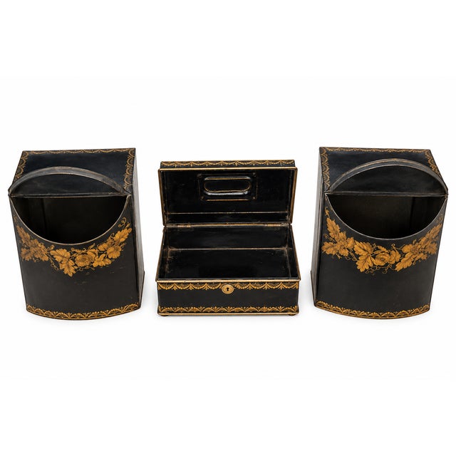 Beautiful vintage three-piece toleware set featuring a rich black ground with ornate gold floral decoration. The...