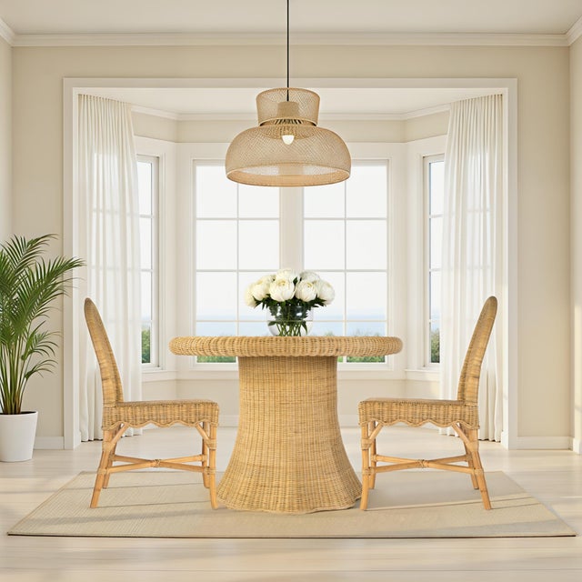 Bring breezy, coastal charm into your home or hospitality space with the Butler Specialty Company Flora Rattan Dining...
