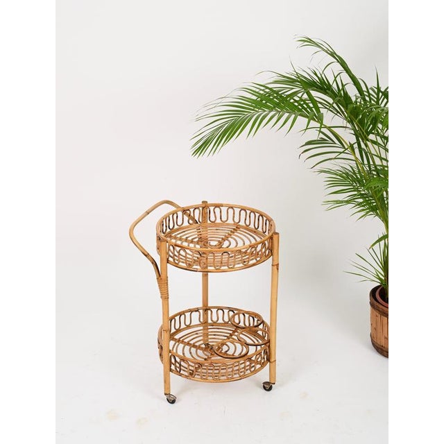 Wonderful French Riviera-style round serving bar cart entirely made of bamboo, curved rattan and hand-woven wicker. This...