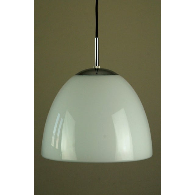 An elegant and increasingly rare pair of delta "klokkependel" pendant lamps produced by louis poulsen, denmark, and first...