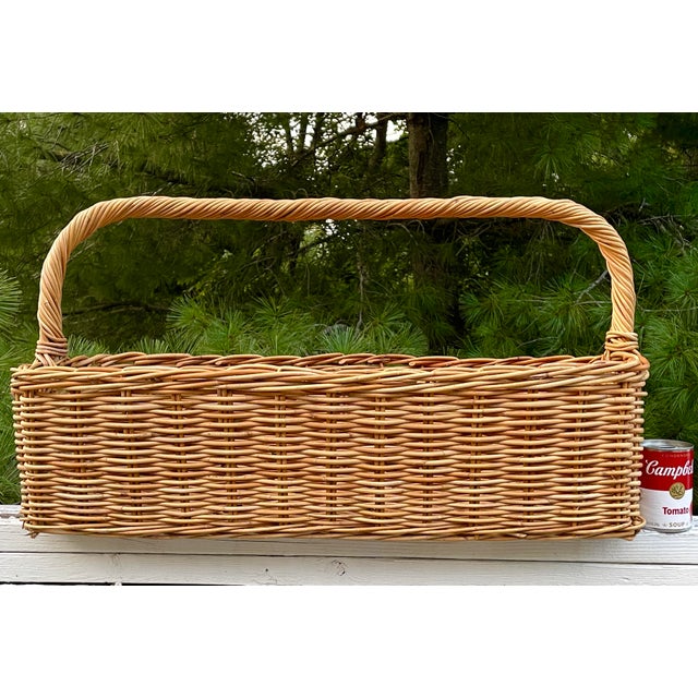 Vintage hand woven wicker basket, 30 inches long by 14 inches wide by 16 inches high at the handle. The weave is tight and...