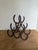 This listing is for an iron horseshoe wine rack. It has an allover patina and is a solid, heavy piece. 14.5" T x 14 5/8" W...