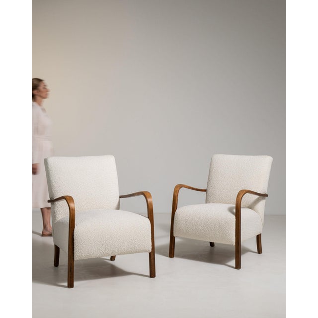 A pair of armchairs whose cream upholstery, dark wood frame gives it real character at first glance. Dating to 1940s and...