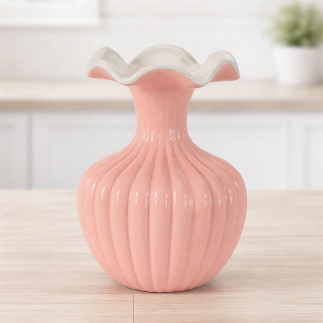 Sweet, stylish, and full of charm, this Pink Ribbed Ruffle Rim Vase is the perfect way to brighten up your home décor....
