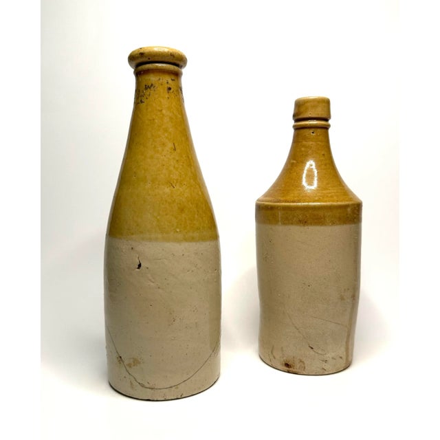 A pair of late 19th to early 20th century antique ale bottles. From research, it is mentioned these vessels were perhaps...