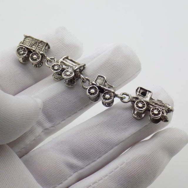 A playful and nostalgic vintage miniature depicting a toy train, handcrafted in Italy during the 1970s and 1980s in...