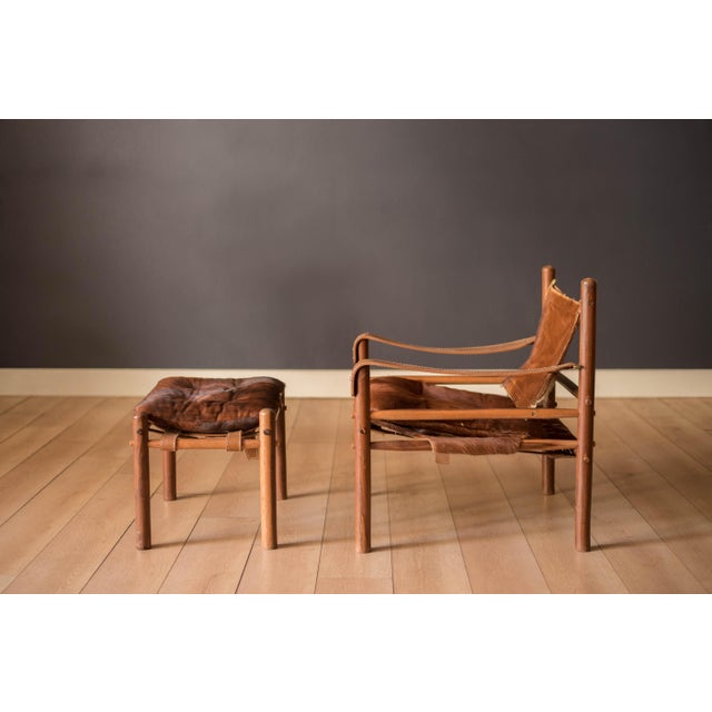 Vintage Sirocco Safari lounge chair and ottoman in rosewood designed by Arne Norell for Möbel AB, Sweden. Features the...