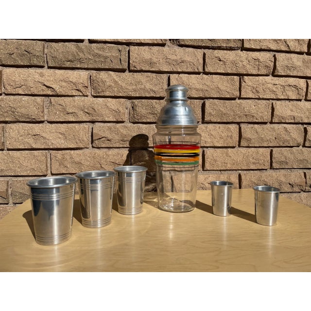Classic retro mid century modern cocktail shaker set. Beautiful blown class cocktail shaker with colorful striped rings...