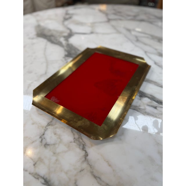 Elegant vintage brass gallery tray featuring a sleek rectangular form with raised brass sides and distinctive folded-...