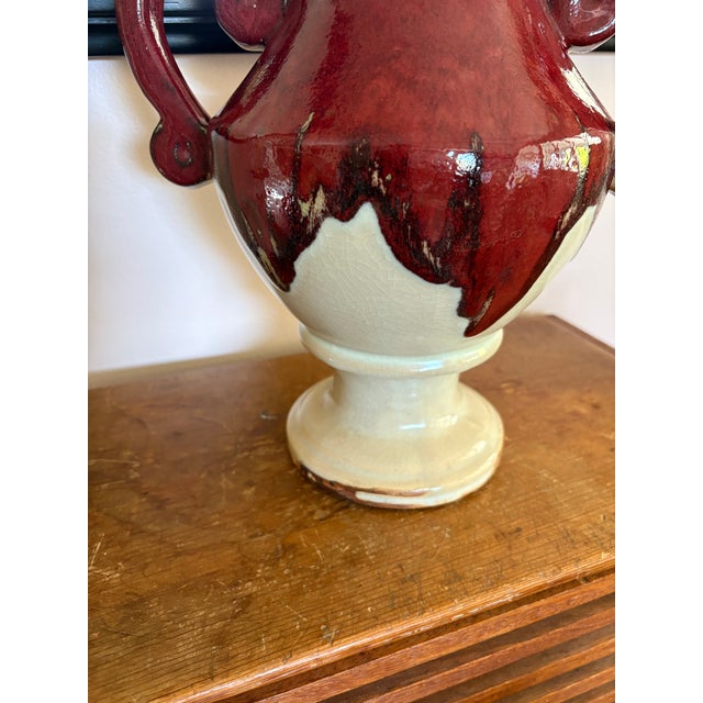 A very striking piece of vintage studio pottery featuring an expressive sculptural form and richly layered oxblood red...