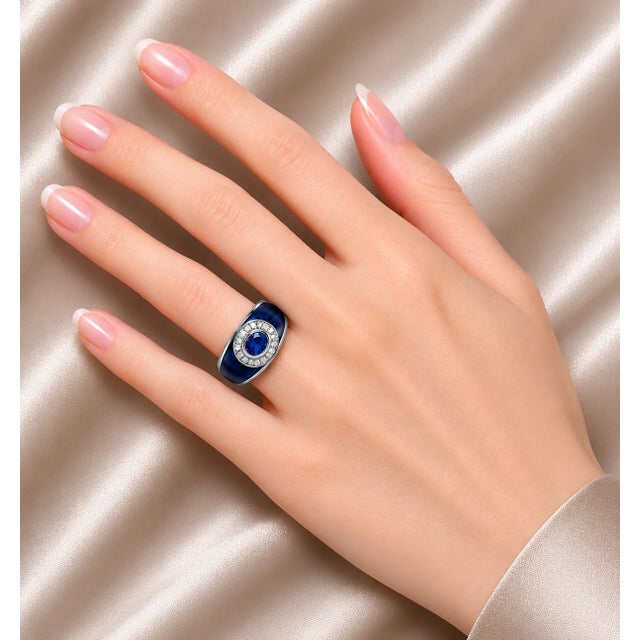 Exquisite 18K White Gold Hidalgo Ring featuring blue enamel, a genuine 6 mm × 4 mm sapphire center stone, and 12 brilliant...