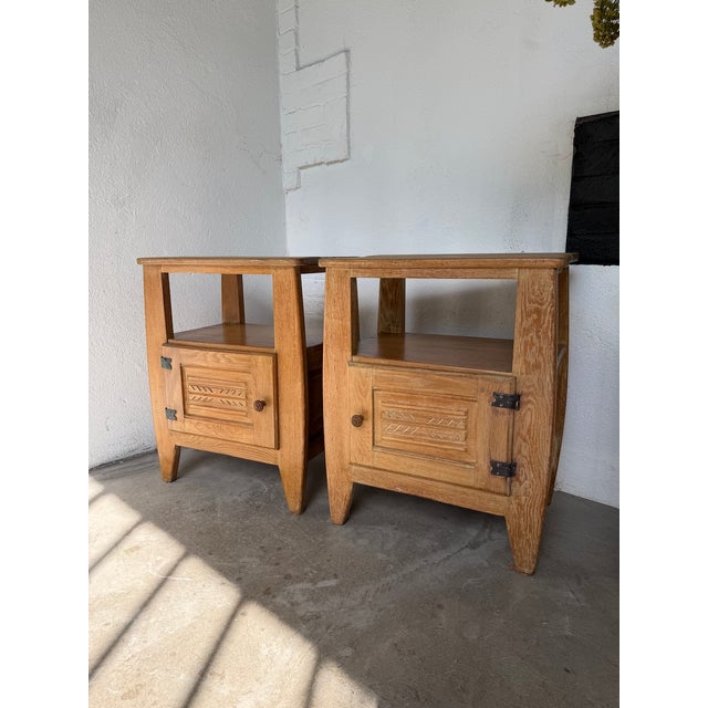 A vintage pair of solid oak bedside tables from the 1950s, reminiscent of the designs of guillerme and chambron. we love...