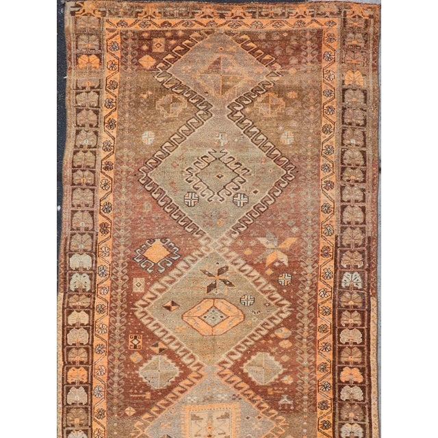 This antique Turkish Kars rug has been hand-knotted in wool and features an all-over, sub-geometric diamond design...