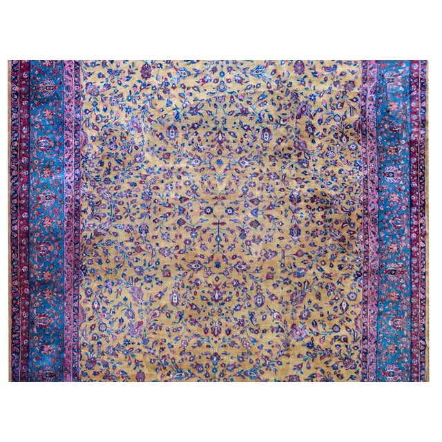 An incredible early 20th century Persian Kashan rug with a beautiful yellow field with a mirrored floral and scrolling...
