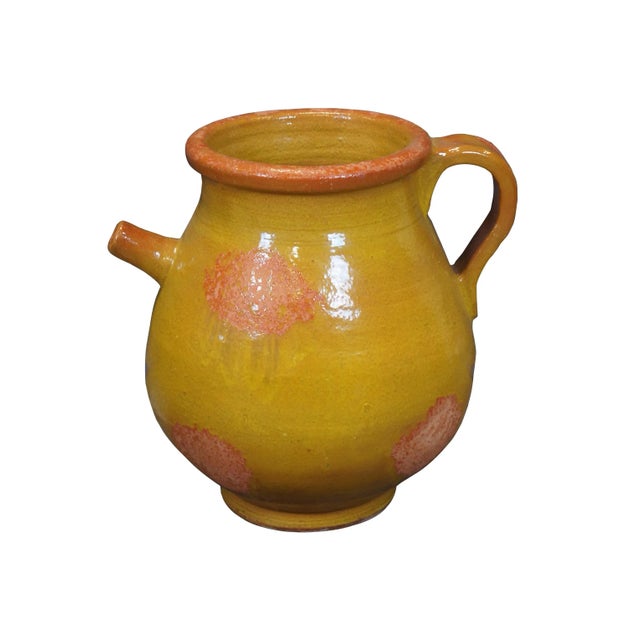 Antique French handcrafted terra cotta olive oil jar / water jug featuring a round shape with footed base, molded rim,...