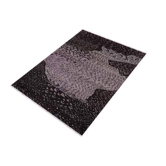 Elevate your interior with this hand-knotted high-low wool area rug, designed to bring depth and dimension to any room....
