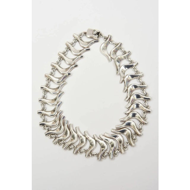 This is part of Chairish’s Costume Jewelry assortment. This set of a sterling silver vintage Mexican Collar necklace and...