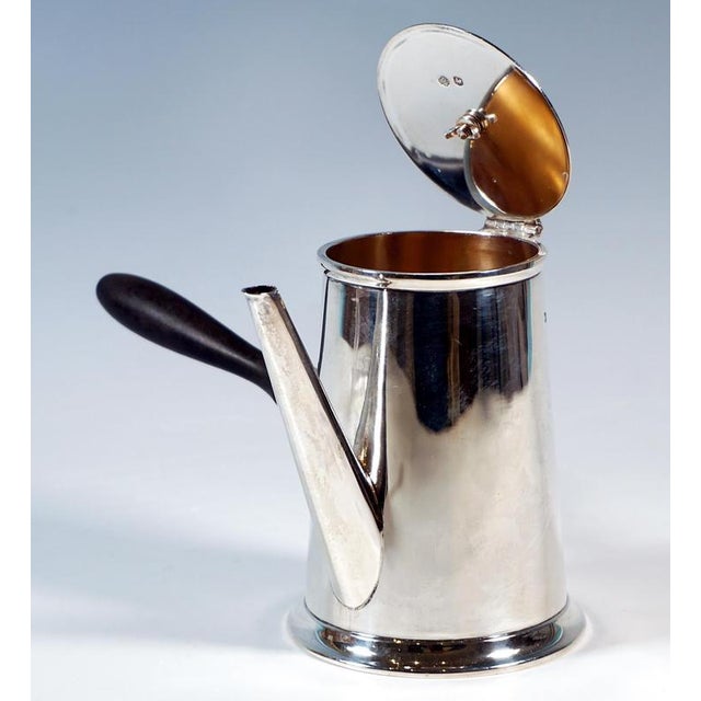 Elegant silver pot with smooth, conical walls, outwardly offset, fluted stepped base ring, smoothly converging spout...
