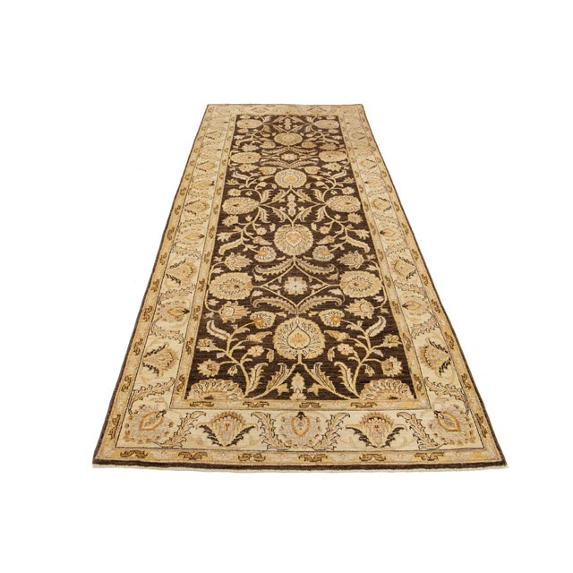 Beautiful modern Peshawar hand-knotted wool runner with a brown field. This rug has a beige accent in an all-over...