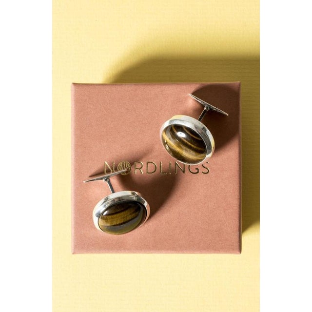 Cool silver cufflinks by Arvo Saarela, in a smooth circular design with large, cabochon cut tigereye stones. 25 grams.