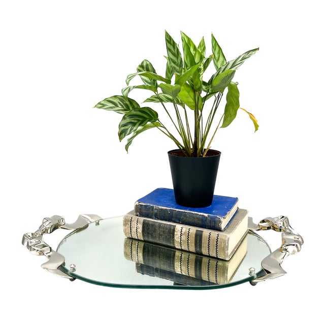 Stunning, 1988 mirrored vanity or serving tray by Godinger, featuring a sculptural silver-plated frame designed as flowing...