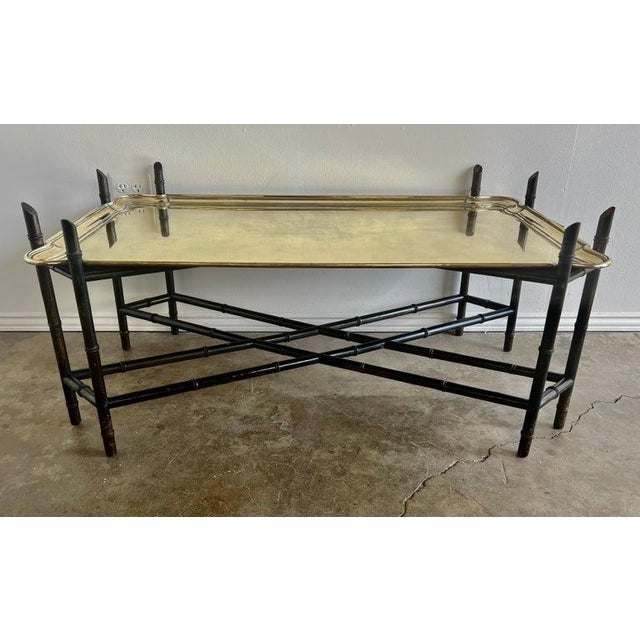 Early 20th century solid brass tray table. The brass tray sits on a carved wood chinoiserie style base with a bottom...