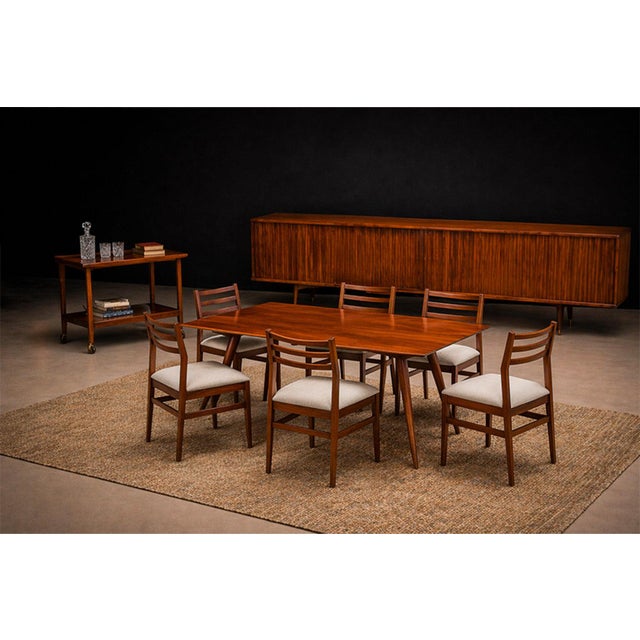 This set of eight chairs exemplifies the refined restraint characteristic of Brazilian mid-century modern design, where...