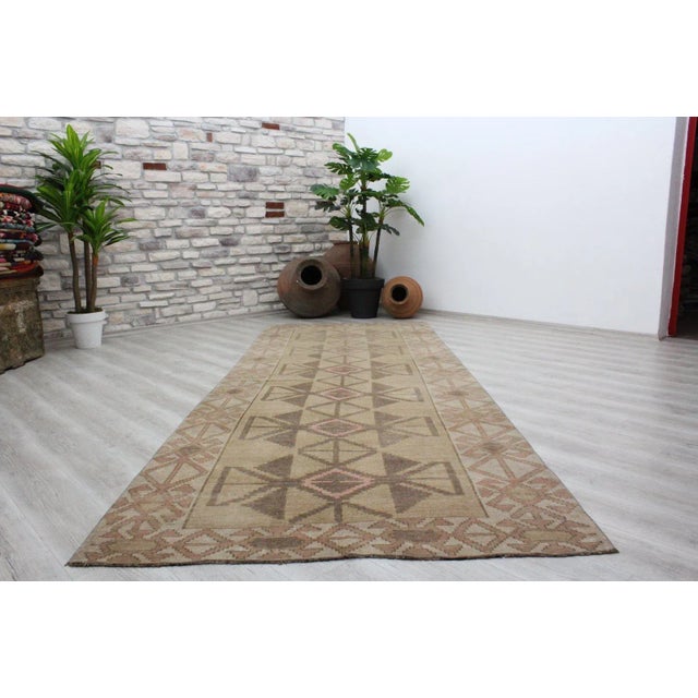This beautiful, traditional vintage, hand knotted Turkish area rug is approximately 60 years old. It is handmade of very...