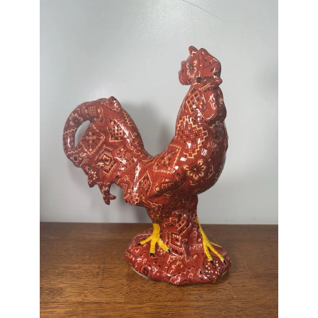 Eye-catching porcelain rooster figurine featuring a vibrant red paisley (bandana-style) pattern with a glossy finish. A...