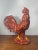 Eye-catching porcelain rooster figurine featuring a vibrant red paisley (bandana-style) pattern with a glossy finish. A...