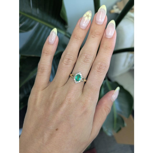 This elegant Colombian emerald ring is crafted in solid 14K gold and features a stunning 7.5x8mm oval-cut emerald with...