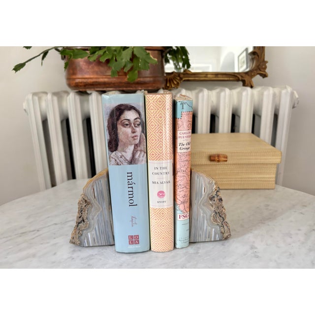 A substantial natural pair of polished agate geode bookends or decorative objects. Colors include shades of light blue,...