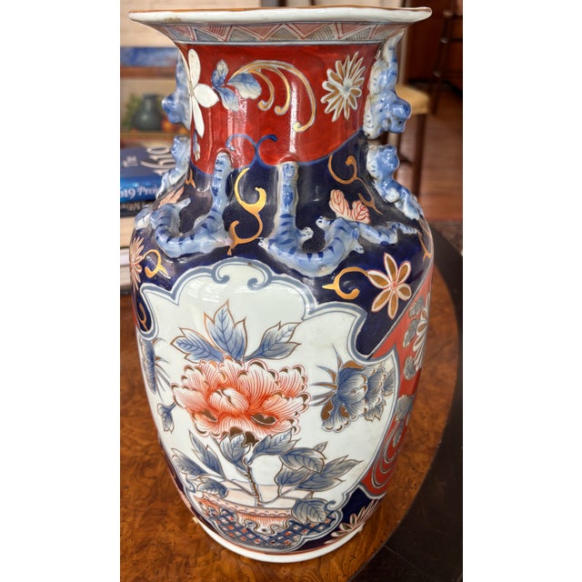 This richly decorated vase features the classic Imari palette of iron red, deep cobalt blue, and White reserve panels plus...