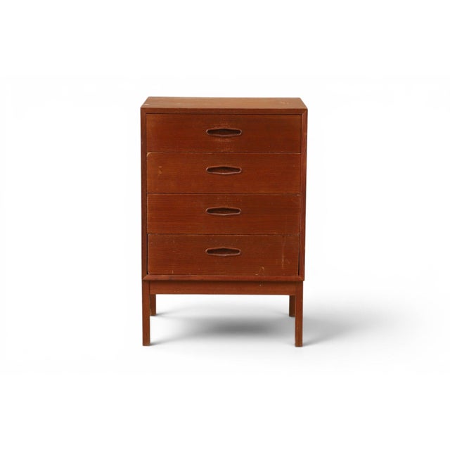 A compact and beautifully proportioned four-drawer teak chest, designed by Nils Jonsson in his iconic "Domi 4" model. The...