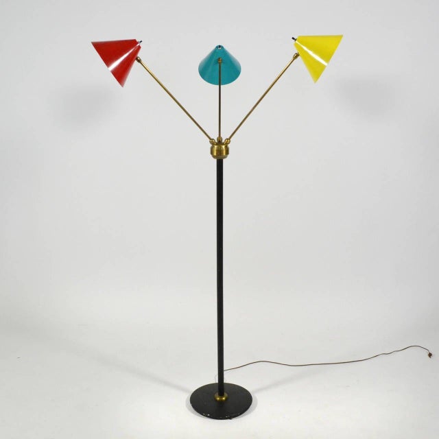 A wonderful example of Italian midcentury lighting, this three-arm floor lamp has conical-shades in red, yellow and blue...