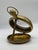 A heavy brass frame that opens with a kickstand or can be left closed on any flat service. It could also be hung though it...