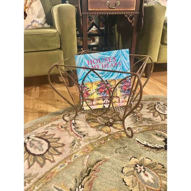 This is a vintage wrought iron magazine rack dating to the mid-20th century, circa 1950s–1960s. The open framework...