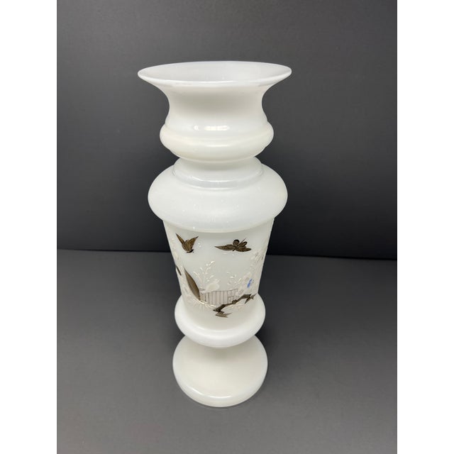 An antique milk glass pedestal vase, 14 inches in height, featuring a refined baluster form and hand-painted silver...