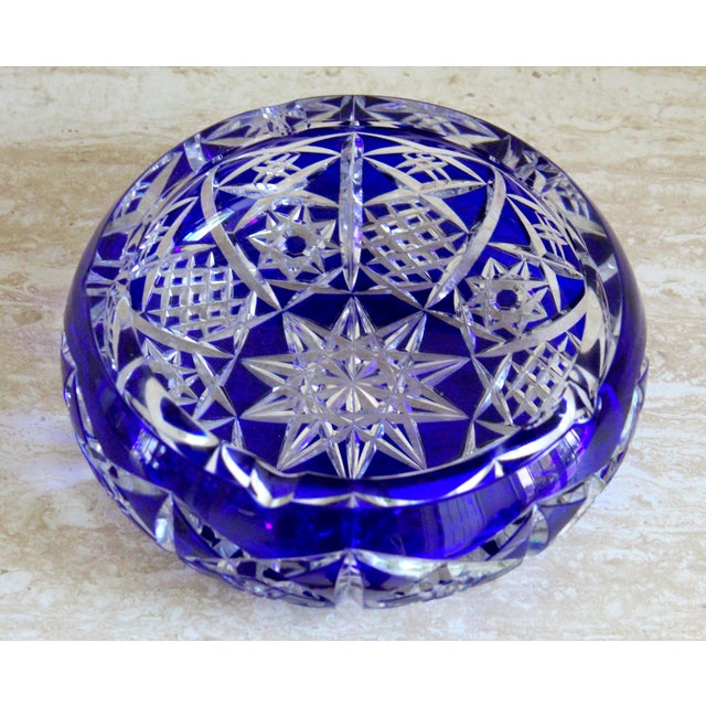 An exquisite vintage cobalt blue cut-to-clear crystal ashtray, showcasing exceptional craftsmanship, brilliant geometric...