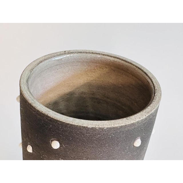 A handcrafted and signed vase by Johannes Andreas Urban, finished with a matte, translucent anthracite glaze that lends...