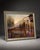 Beautiful framed garden landscape artwork featuring a gazebo, flowers, pond, trees, and warm sunset lighting. The scene...