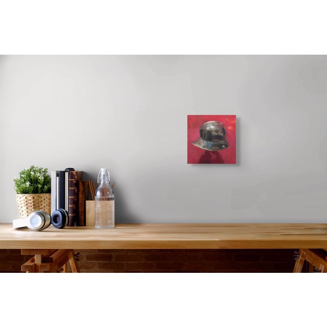 Helmet for the Ghost by Elena Burykina | Oil on panel Painting of a metallic helmet on a red background For Sale - Image 4 of 5